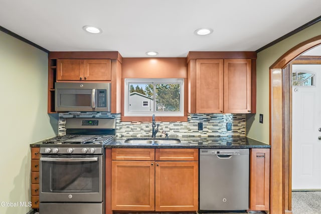 2289 Hickory Hill Rd, Mohawk, NY 12068 - kitchen with stainless steel appliances, arched walkways, decorative backsplash, dark stone countertops, and brown cabinets