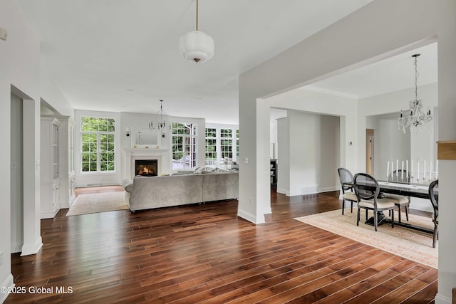 13 Bridlewood Loop, Clifton Park, NY 12148 - living room featuring a chandelier, dark wood-style floors, and a glass covered fireplace