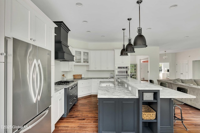 13 Bridlewood Loop, Clifton Park, NY 12148 - kitchen featuring appliances with stainless steel finishes, white cabinetry, dark wood-type flooring, open floor plan, and a large island