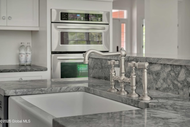 13 Bridlewood Loop, Clifton Park, NY 12148 - kitchen with double oven, backsplash, white cabinets, and stone counters