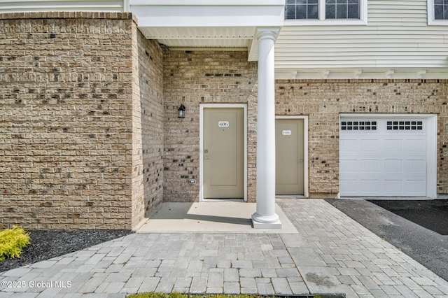 606 Vly Pointe Dr, Niskayuna, NY 12309 - view of exterior entry featuring brick siding and an attached garage