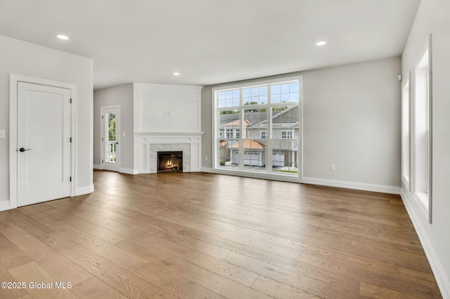 606 Vly Pointe Dr, Niskayuna, NY 12309 - unfurnished living room featuring light wood-type flooring, healthy amount of natural light, a fireplace, and recessed lighting