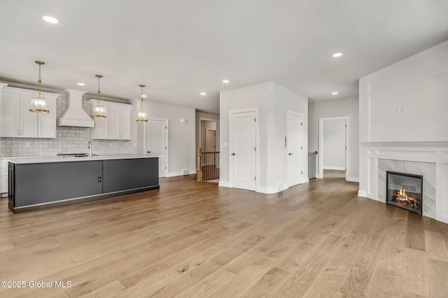 606 Vly Pointe Dr, Niskayuna, NY 12309 - unfurnished living room with recessed lighting, light wood finished floors, and a premium fireplace