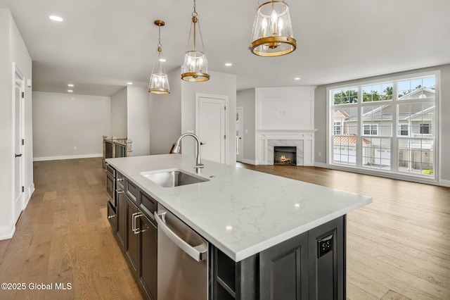 606 Vly Pointe Dr, Niskayuna, NY 12309 - kitchen with dishwasher, light wood-type flooring, a fireplace, hanging light fixtures, and recessed lighting