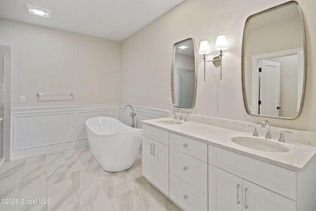 606 Vly Pointe Dr, Niskayuna, NY 12309 - full bath with a freestanding bath, double vanity, marble finish flooring, wainscoting, and a decorative wall