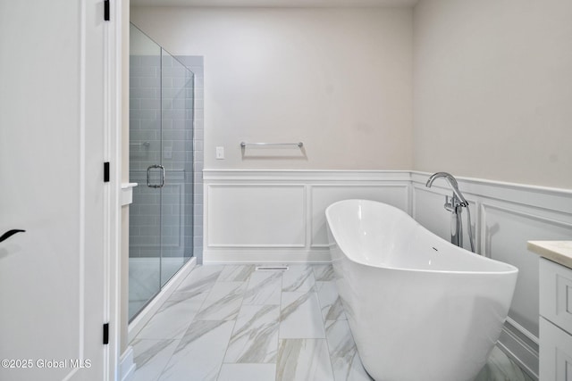 606 Vly Pointe Dr, Niskayuna, NY 12309 - full bathroom with a stall shower, a soaking tub, a wainscoted wall, marble look tiles, and vanity