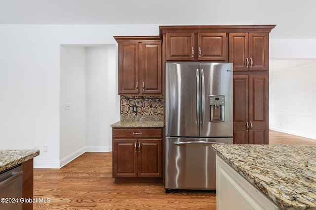 13 Macory Way, Moreau, NY 12831 - kitchen with appliances with stainless steel finishes, light stone countertops, decorative backsplash, and light wood-style flooring