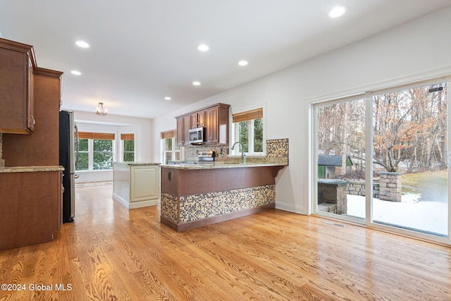 13 Macory Way, Moreau, NY 12831 - kitchen with stainless steel appliances, light wood-style flooring, a peninsula, recessed lighting, and light stone countertops