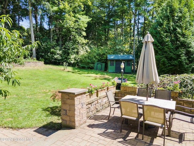 13 Macory Way, Moreau, NY 12831 - view of patio / terrace featuring outdoor dining area and a storage unit