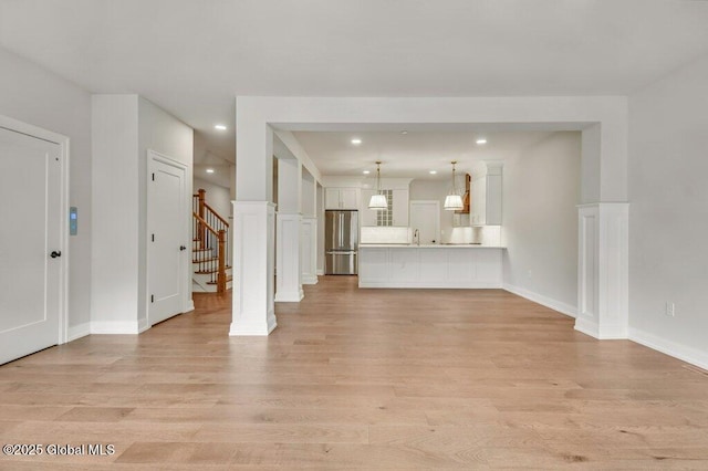 602 Vly Pointe Dr, Niskayuna, NY 12309 - unfurnished living room featuring light wood-style floors, stairway, and recessed lighting