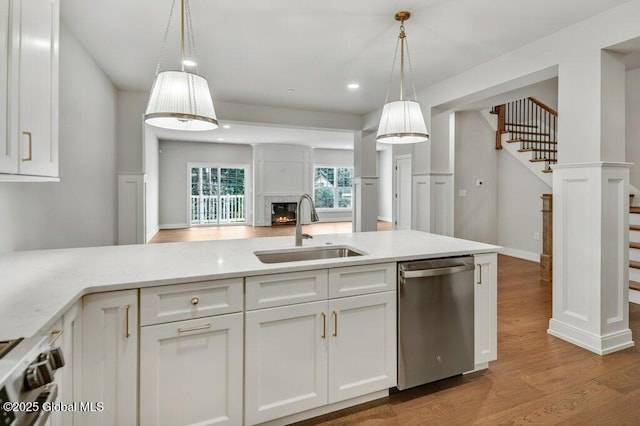 602 Vly Pointe Dr, Niskayuna, NY 12309 - kitchen featuring stainless steel dishwasher, wood finished floors, white cabinets, range, and open floor plan