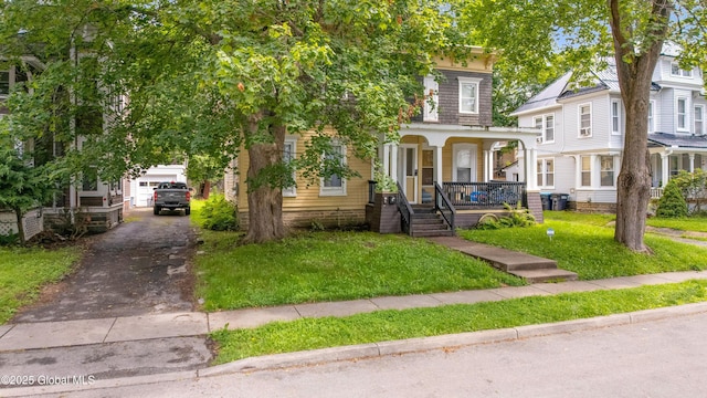 31 Cedar St, Oneonta, NY 13820 - view of front of home with covered porch, a front lawn, and driveway