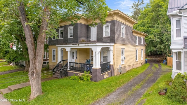 31 Cedar St, Oneonta, NY 13820 - italianate-style house with covered porch and a front lawn