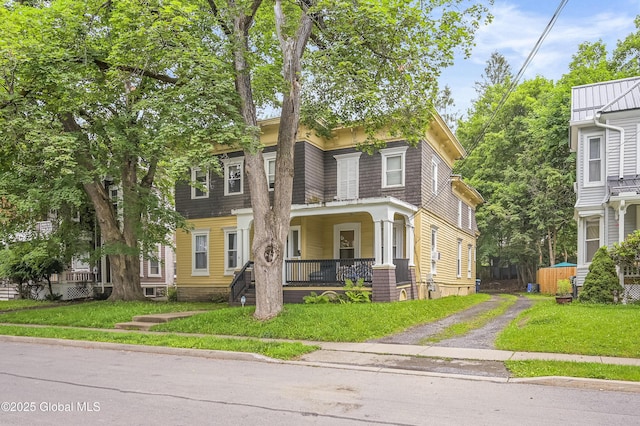 31 Cedar St, Oneonta, NY 13820 - view of front of house with a porch, driveway, and a front lawn