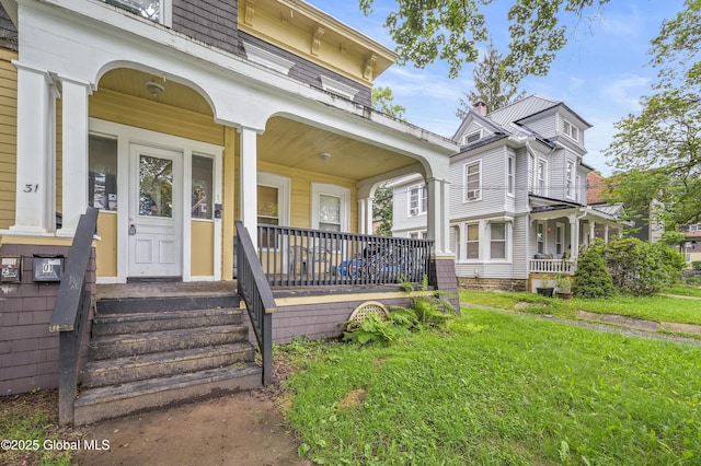 31 Cedar St, Oneonta, NY 13820 - view of front of home featuring covered porch and a front yard