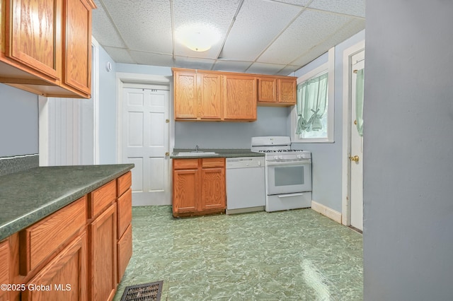 31 Cedar St, Oneonta, NY 13820 - kitchen with white appliances, a paneled ceiling, light floors, and dark countertops