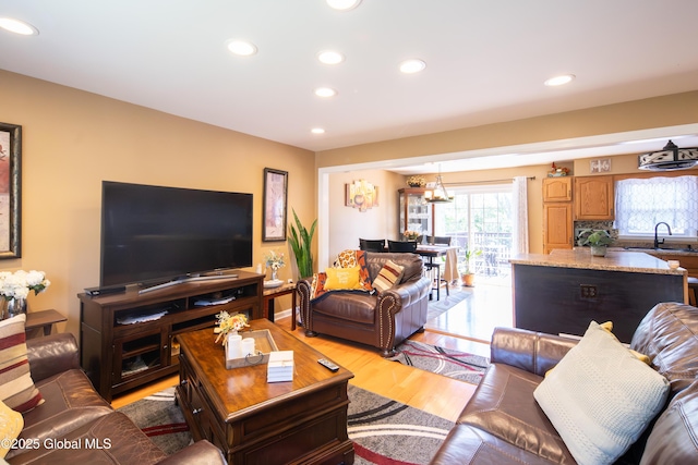 99 Fiddlers Ln, Colonie, NY 12110 - living room with recessed lighting, light wood finished floors, and a chandelier