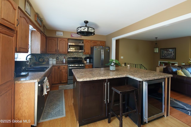 99 Fiddlers Ln, Colonie, NY 12110 - kitchen with stainless steel appliances, wine cooler, tasteful backsplash, a center island, and light countertops