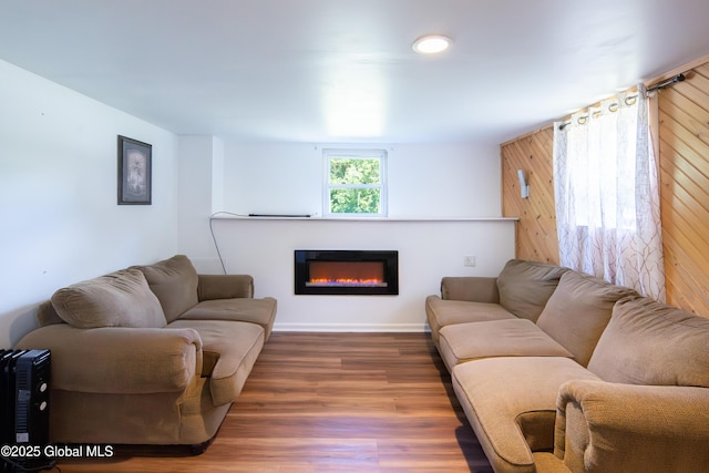 99 Fiddlers Ln, Colonie, NY 12110 - living room featuring a glass covered fireplace, wood finished floors, and wood walls