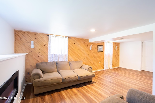 99 Fiddlers Ln, Colonie, NY 12110 - living area with wooden walls, wood finished floors, and a fireplace