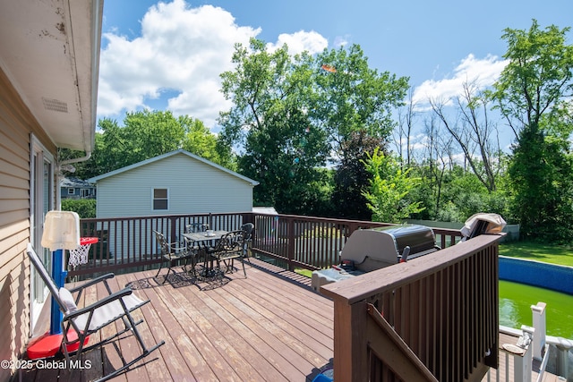 99 Fiddlers Ln, Colonie, NY 12110 - wooden terrace featuring outdoor dining space and view of scattered trees