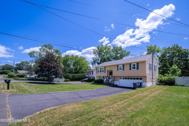 99 Fiddlers Ln, Colonie, NY 12110 - split foyer home featuring an attached garage, driveway, and a front lawn
