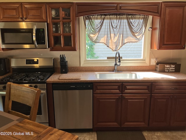 56 Pershing Dr, Scotia, NY 12302 - kitchen with stainless steel appliances, glass insert cabinets, and light countertops