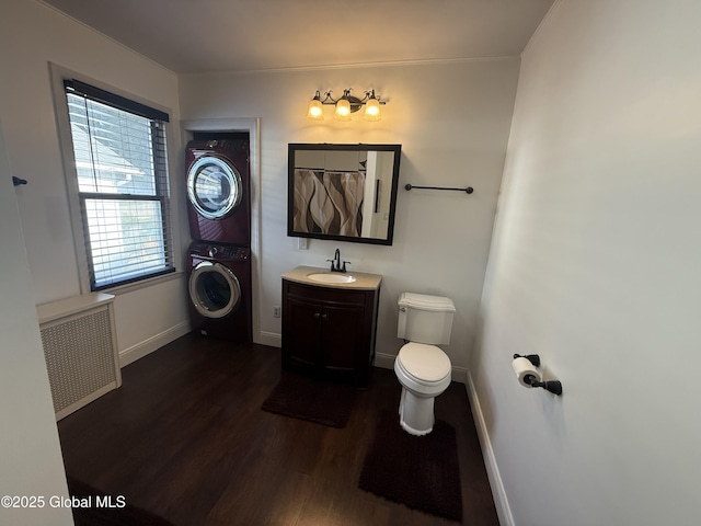 56 Pershing Dr, Scotia, NY 12302 - bathroom with stacked washer / dryer, wood finished floors, vanity, and radiator heating unit