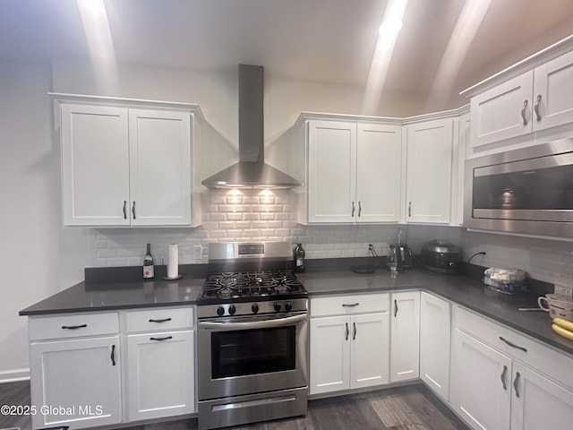 30B Idared Ln, Halfmoon, NY 12065 - kitchen featuring wall chimney range hood, appliances with stainless steel finishes, dark countertops, white cabinetry, and vaulted ceiling