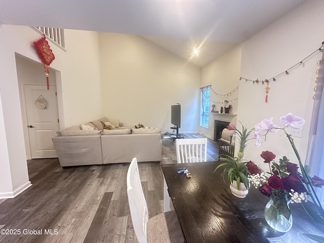 30B Idared Ln, Halfmoon, NY 12065 - dining space with dark wood-style floors, a fireplace, and high vaulted ceiling