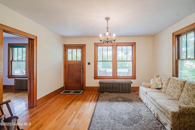 3063 Ny Highway 43, Sand Lake, NY 12018 - foyer featuring radiator, a chandelier, and light wood-type flooring