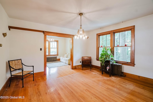 3063 Ny Highway 43, Sand Lake, NY 12018 - sitting room featuring a chandelier, radiator heating unit, and plenty of natural light