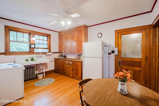 3063 Ny Highway 43, Sand Lake, NY 12018 - kitchen featuring freestanding refrigerator, range, radiator, light wood-style floors, and a ceiling fan