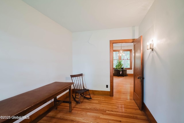 3063 Ny Highway 43, Sand Lake, NY 12018 - hall featuring wood finished floors and a chandelier