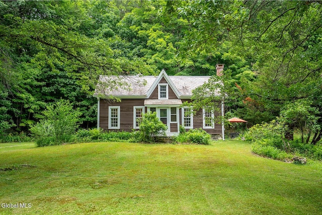 203 Center Rd, White Creek, NY 12057 - view of front facade featuring a chimney, a front yard, and a wooded view