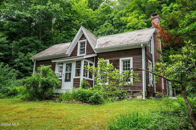 203 Center Rd, White Creek, NY 12057 - view of front facade with a chimney, a front yard, and a view of trees