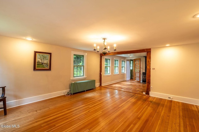 203 Center Rd, White Creek, NY 12057 - empty room with radiator heating unit, a chandelier, light wood-style floors, and recessed lighting