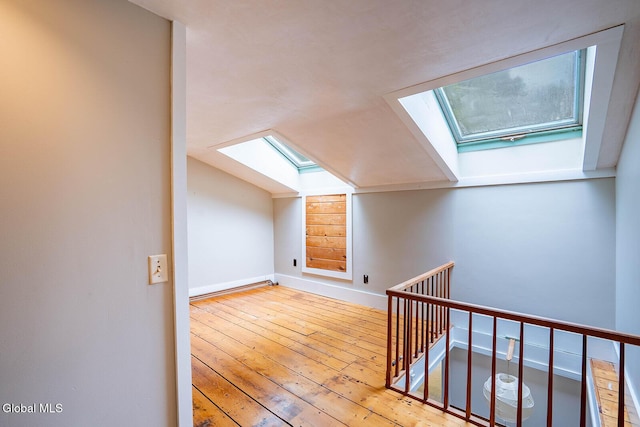203 Center Rd, White Creek, NY 12057 - additional living space with a skylight, lofted ceiling, and hardwood / wood-style floors