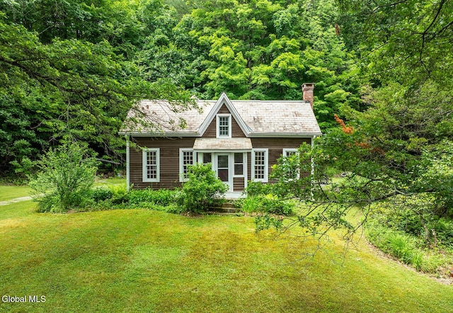 203 Center Rd, White Creek, NY 12057 - view of front of home featuring a chimney, a front yard, and a view of trees