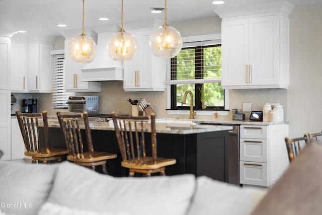 55 Trinity Rock Rd, Lake George, NY 12845 - kitchen with dishwashing machine, white cabinets, a kitchen bar, decorative backsplash, and recessed lighting