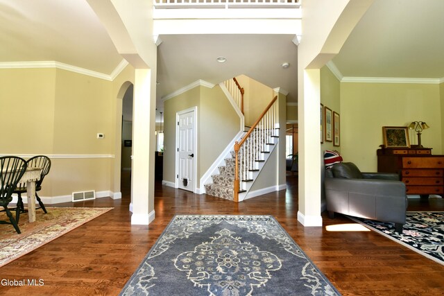 96 Masters Cmn N, Queensbury, NY 12804 - foyer entrance featuring arched walkways, stairway, wood finished floors, and ornamental molding