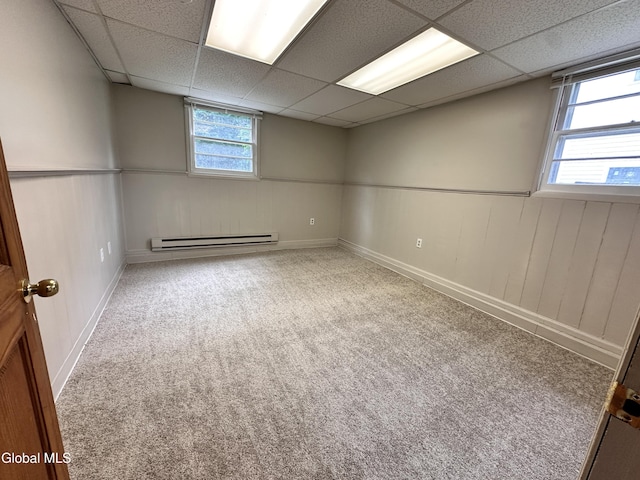 1 S Main St, Voorheesville, NY 12186 - carpeted empty room with a baseboard heating unit and a paneled ceiling