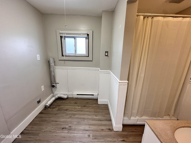 1 S Main St, Voorheesville, NY 12186 - washroom with dark wood-style flooring, a baseboard radiator, and wainscoting