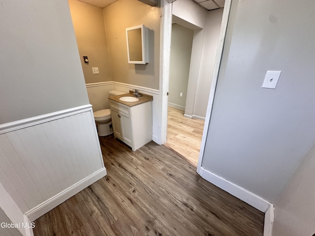 1 S Main St, Voorheesville, NY 12186 - bathroom with wood finished floors, vanity, and a wainscoted wall