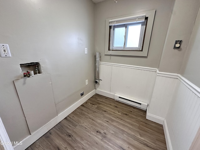 1 S Main St, Voorheesville, NY 12186 - laundry room with a baseboard heating unit, a wainscoted wall, wood finished floors, hookup for a washing machine, and a decorative wall