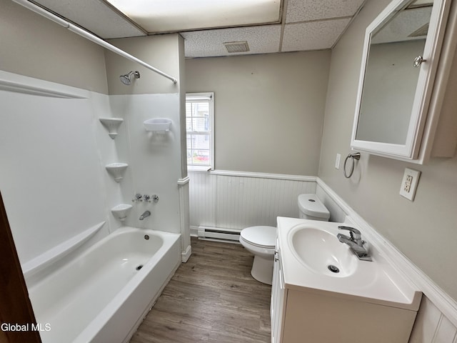 1 S Main St, Voorheesville, NY 12186 - full bathroom with a baseboard radiator, a wainscoted wall, shower / tub combination, vanity, and wood finished floors