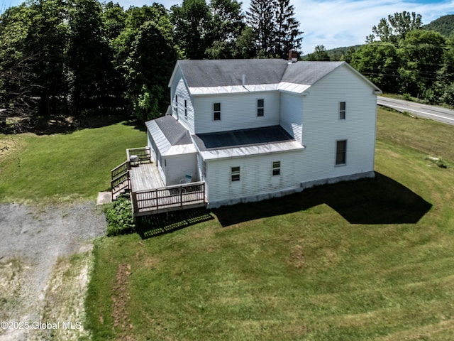 17564 State Route 22, Berlin, NY 12022 - view of front of home with a wooden deck, a front yard, a chimney, and a metal roof