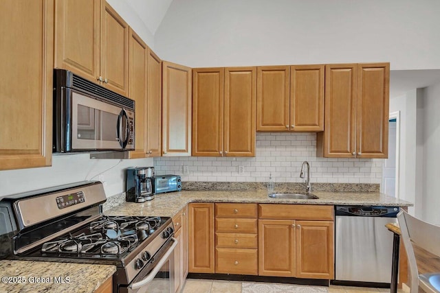 8 Trailside Dr Unit B10, Hunter, NY 12442 - kitchen with stainless steel appliances, backsplash, light stone counters, light tile patterned floors, and vaulted ceiling