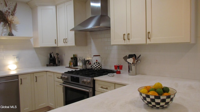 32 Winnie St, Albany, NY 12208 - kitchen with wall chimney range hood, stainless steel appliances, light countertops, and backsplash