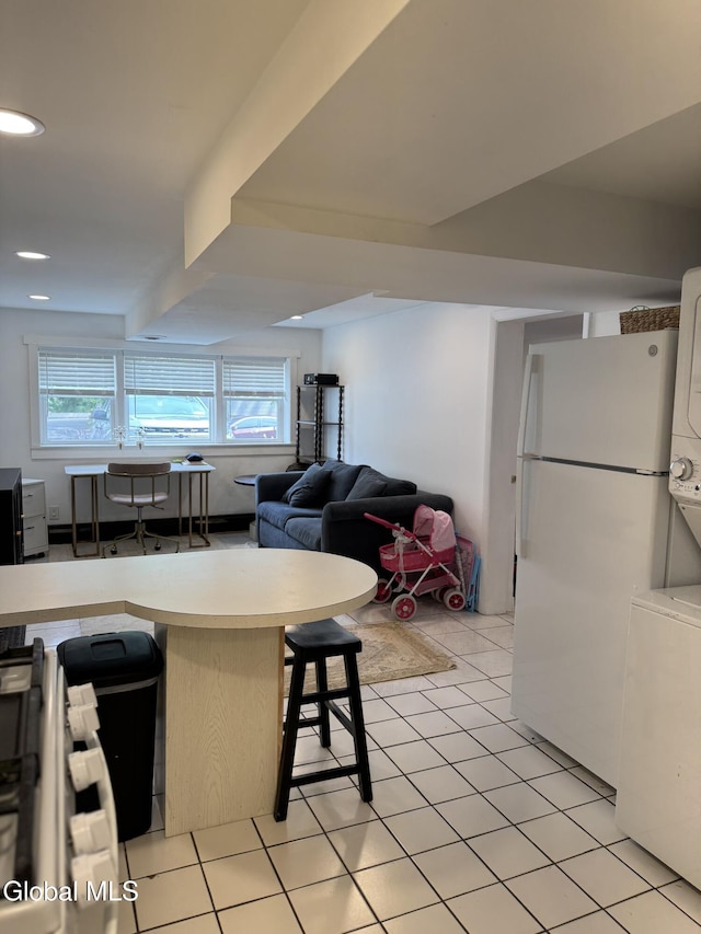 32 Winnie St, Albany, NY 12208 - living room featuring stacked washer and clothes dryer, plenty of natural light, recessed lighting, and light tile patterned floors